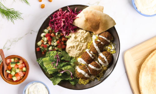 a Mediterranean dinner plate with pita on the side